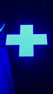 Blue Neon Sign With A Cross The atmosphere of a hospital Pharmacy Glowing over A Wet Alley, Visible LED texture, Rain-Splattered Facade, Gloomy Cyberpunk Atmosphere, Contrasting shadows, Electric Coba