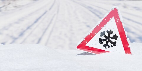 Snow and ice warning roadsign in snow heap with road background with copy space
