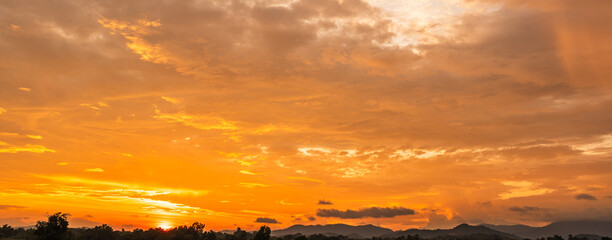 Evening sky,amazing colorful dusk sky and dramatic sunset cloud on twilight,majestic sunlight on cloud fluffy,idyllic nature peaceful background,beauty dark blue,purple sky over silhouette mountain