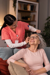 Fototapeta premium Nurse Combing Senior Woman's Hair