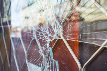 Crime prevention and vandalism concept. Broken display window of a shop.