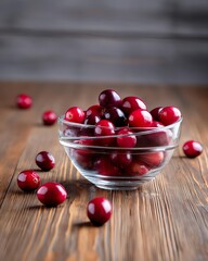 A bowl of fresh, vibrant cranberries sits on a rustic wooden surface, surrounded by scattered berries, showcasing their rich color and natural beauty.