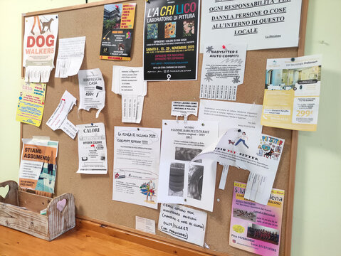 Rome, Italy - December 18, 2025: Community bulletin board filled with colorful flyers and announcements, showcasing local events, services, and opportunities for residents in a vibrant neighborhood