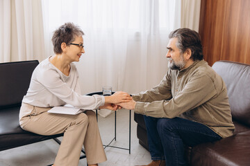 Psychologist giving emotional support to senior patient