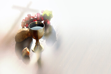 Bread and wine symbolizing the blood and body of Jesus Christ, the Holy Cross, and the background of the Eucharist
