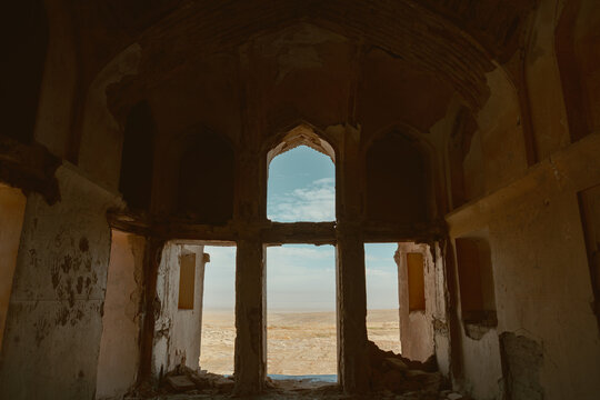 Interior view from inside the historic Abbas Abad mansion, Natanz, Isfahan, which offers a vast, arid view of the desert through arched openings.