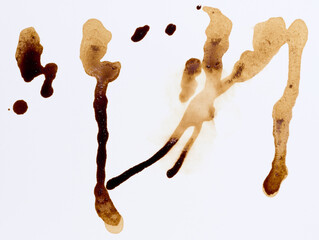 Spilled coffee, long vertical streaks, uneven brown texture, drops of different sizes.