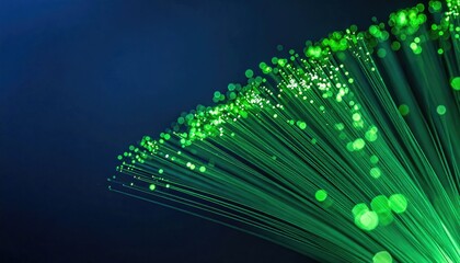 Abstract fiber optic strands emerge from darkness, lit with bright, pulsing green light. Bokeh effect