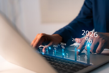 New Year 2026 Business start-up to goals, A businessman touches taps start-up button 2025 to 2026 for New Year 2026, sets goals, for develops strategies to achieve better results success in the future