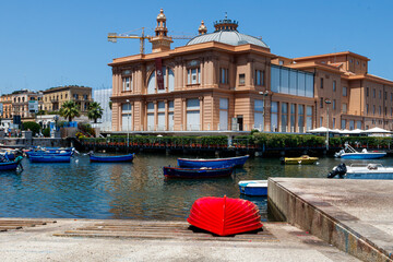 Colorful boats moored near historic building in harbor