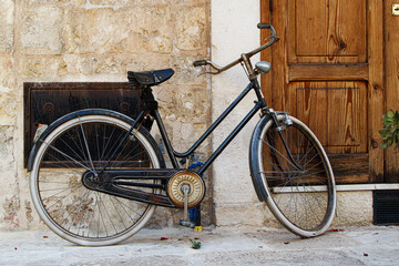 Vintage bicycle leaning against rustic stone wall