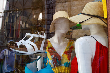 Summer fashion store window with dresses and hats