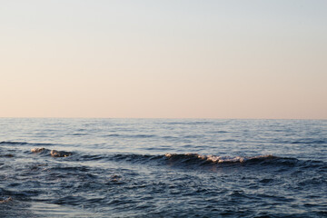 Waves crashing on sea surface during golden hour