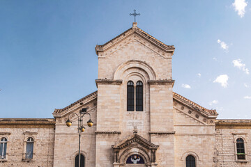 Facade of historic italian stone church under clear sky