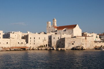 Historic church and white stone buildings by the sea