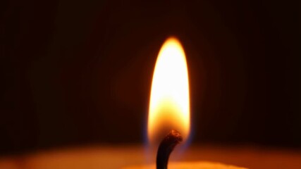 Gentle flicker of candle flame in tranquil darkness captured in slow motion - Powered by Adobe