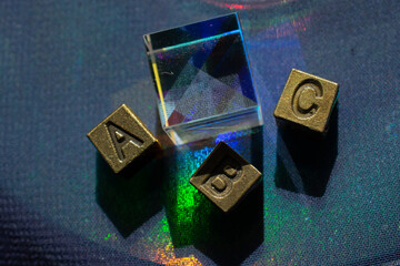 ABC Word text on metal cube blocks beside Optical glass cubes