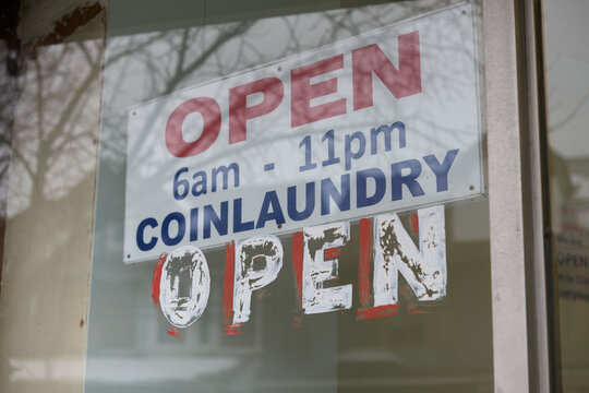 sign of an old coin laundry open 6am - 11pm