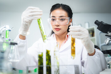 Scientist comparing algae samples in modern laboratory to study renewable bioenergy, biotechnology, and sustainable innovation, support eco-friendly solutions, clean power, and alternative energy.