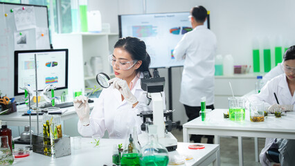 Research team analyzing plant samples in a modern laboratory, focusing on plant biology, sustainability science, environmental research, teamwork, and innovative eco-friendly for a sustainable future.