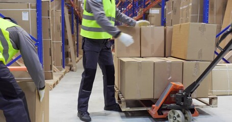 Warehouse workers loading pallet boxes for shipping. Manual pallet jack moves cartons in a distribution warehouse for efficient transport and safe loading. Strong concept of delivery logistics. - Powered by Adobe