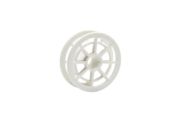 Isolated shot of a white plastic wheel shape with detailed spoke design on flat surface