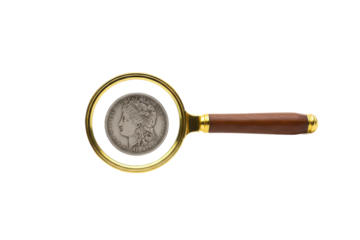 Magnifying glass scrutinizing an antique coin revealing intricate details and historical value