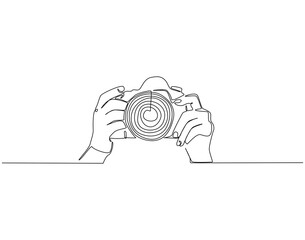 Continuous line drawing of hand holding camera. Single line illustration of hand hold camera. Photograph, journalist concept. Editable outline