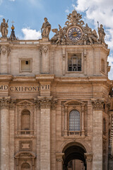 Fototapeta premium Vatican - Vatican City - St Peters Basilica - Architectural detail of facade with large clock window and Corinthian pilasters