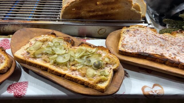 Polish zapiekanka at the Krakow Christmas market, Poland. A traditional Polish hot sandwich with cheese and filling. A variety of flavors.