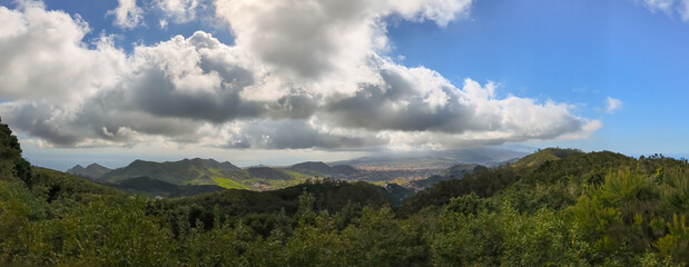 Panoramic Green Valley Under Dramatic Clouds