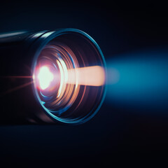 Home projector casting light beam in dark room