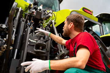 Male mechanic inspecting agricultural machinery © Igor Barilo