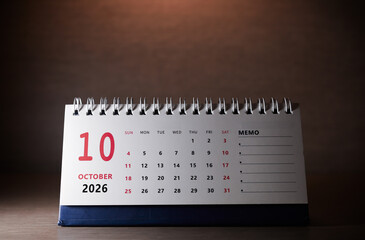Calendar page of October 2026 on desk, with copy space. monthly planning concept, important schedules, meetings, and appointments.