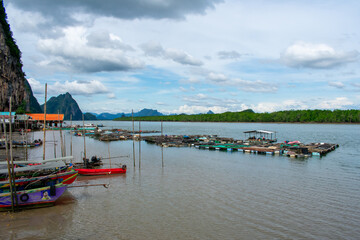 Koh Panyi floating Muslim village in Thailand. Boats and limestone rock formations on Andaman Sea, Phi Phi islands 