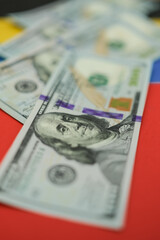 United States dollars are on the national colors of the Venezuelan flag. Shallow depth of field.