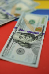United States dollars are on the national colors of the Venezuelan flag. Shallow depth of field.