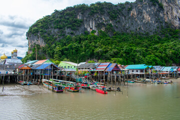 Koh Panyi floating Muslim village in Thailand. Boats and limestone rock formations on Andaman Sea, Phi Phi islands 