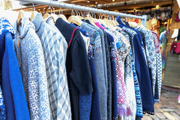 Winter wool clothing displayed for holiday sale.