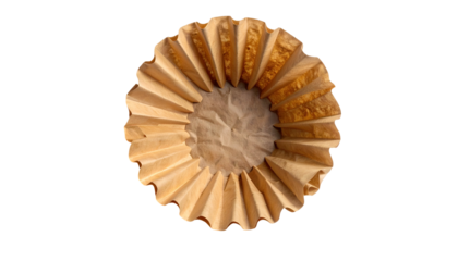 Overhead view of a used, crinkled brown paper coffee filter, with a black background