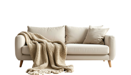 Neutral-toned sofa with two pillows, wooden legs, and a draped cozy blanket