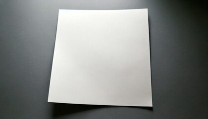 White paper sheet on a dark gray background with subtle shadow.