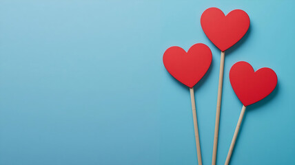 Red wooden hearts on blue background minimal flat lay - ideal for Valentine's Day greeting cards and romantic social media posts.