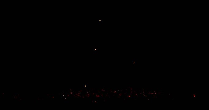 Realistic fire sparks falling down, isolated on a black background. Perfect as a cinematic VFX overlay, fire particles effect or visual element. Shot in slow motion.