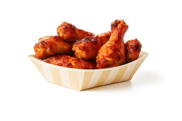Delicious glazed chicken wings and drumettes in a paper tray presenting savory comfort food, sticky sauce coating, party snack appeal, casual dining style, and mouthwatering fast food flavor