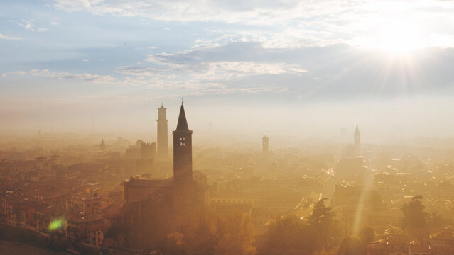 Verona skyline in morning mist with soft sun rays