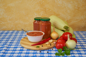 fresh vegetables and homemade sauce in jars on the table, Composition of fresh vegetables and homemade preservation