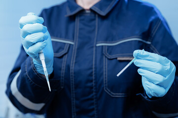 Gloved technician handling pcr testing for milk equipment in laboratory setting, analysis for presence of antibiotics and acidity