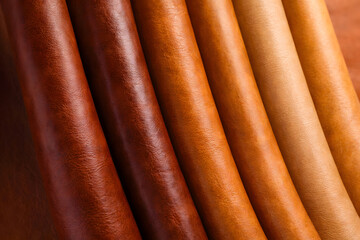 Rich tones of brown leather material folds highlighting luxury texture, premium craftsmanship, durable upholstery fabric, refined fashion material, and elegant industrial design background