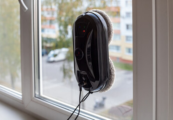 Window cleaning robot is installed on the inside of an apartment window and is ready to use.